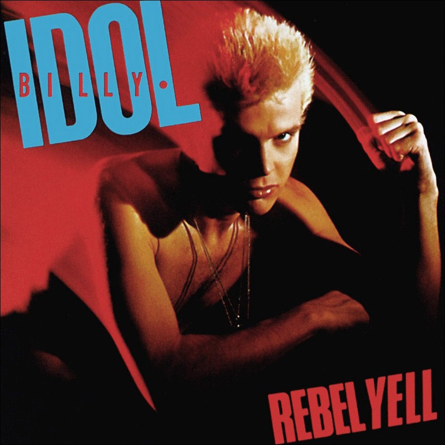 Album cover of Billy Idol's "Rebel Yell" featuring Billy Idol with platinum blonde hair and a serious expression, leaning forward in a low-light setting with red and black background, and bold blue and red text.