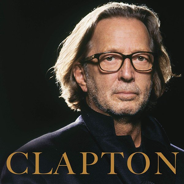 Close-up of a man with shoulder-length gray hair, glasses, and a serious expression, with the word 'CLAPTON' in large gold letters at the bottom.
