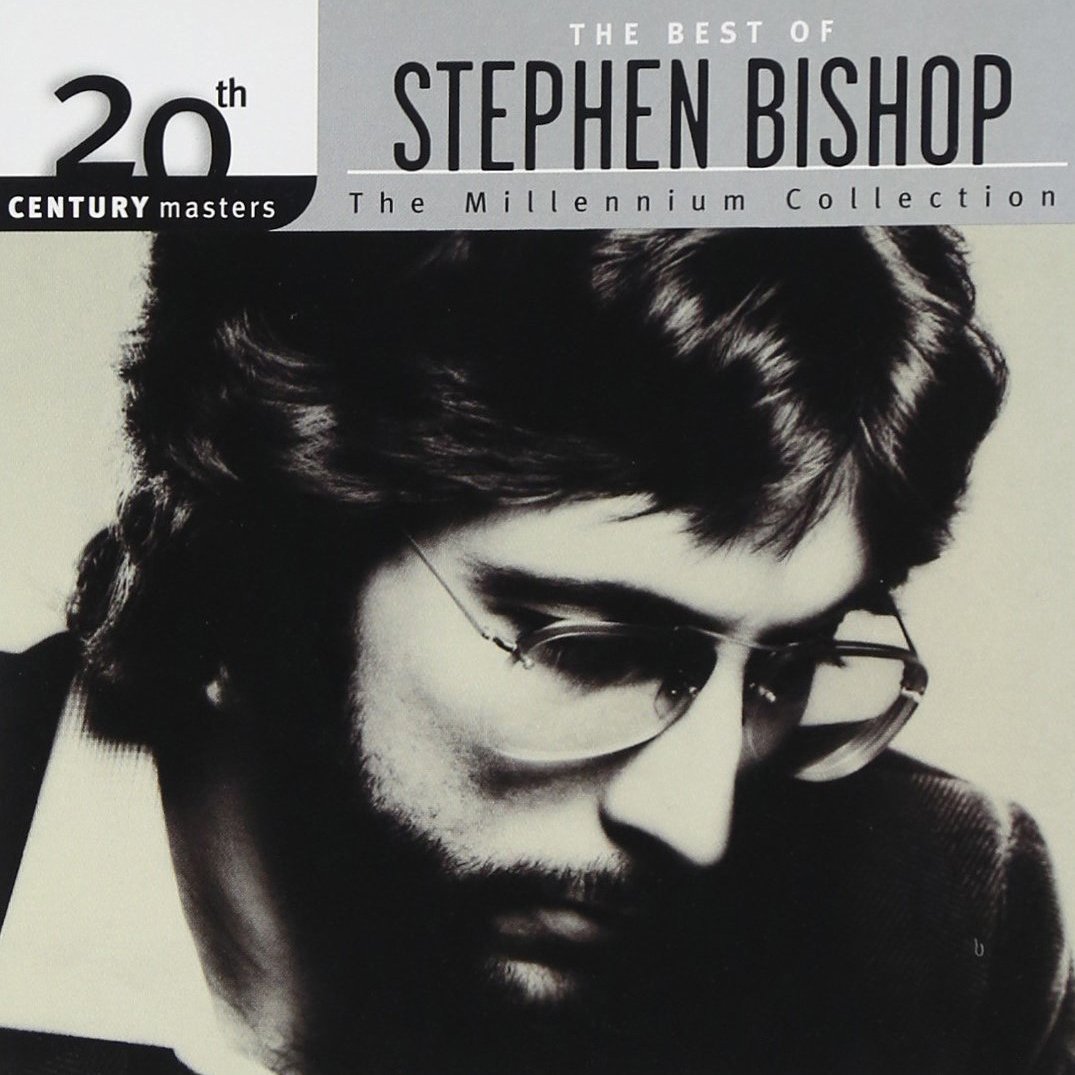 Album cover featuring a black-and-white photo of Stephen Bishop with glasses, for 'The Best of Stephen Bishop: The Millennium Collection,' celebrating 20th century music masters.